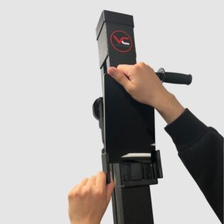 Close-up of a tablet being fitted into the holder of the VersaClimber H-TS model, demonstrating how to securely place the device for accessing on-demand fitness classes and workout tracking.
