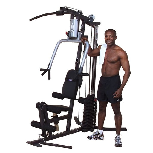 Full view of Body-Solid G3S Home Gym with all attachments and black male after workout posing at machine